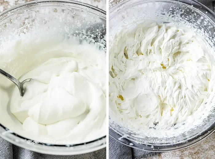 Whipped cream in a clear bowl with a spoon